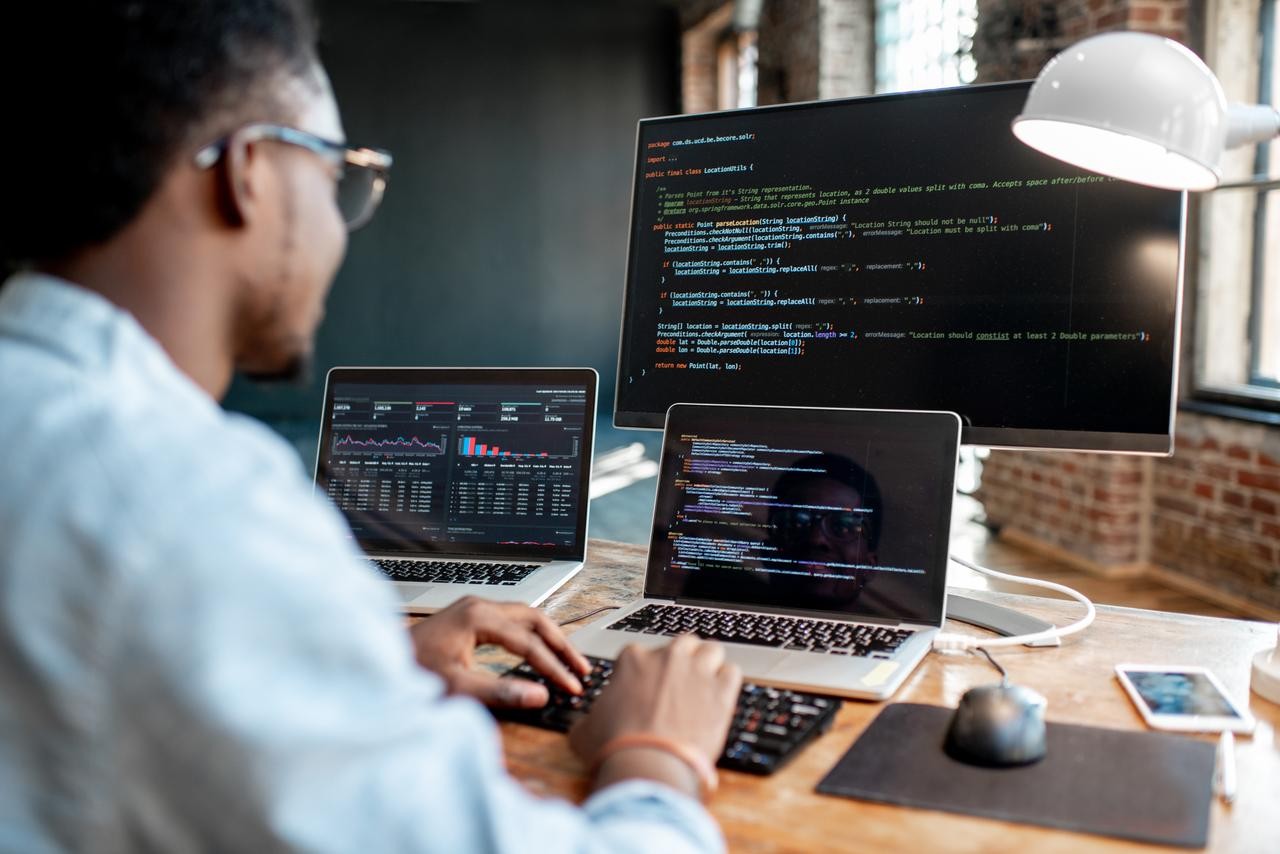 Man working at his laptops with monitor